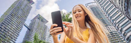 Woman Tourist using navigation app on the mobile phone. Navigation map on a smartphone in a big city...