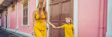 BANNER, LONG FORMAT Mom and son tourists on the Street in the Portugese style Romani in Phuket Town. Also called Chinatown or the old town. Traveling with kids conceptの写真素材