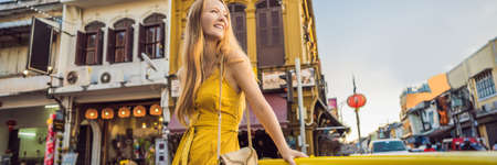Woman tourist on the Street in the Portugese style Romani in Phuket Town. Also called Chinatown or the old town BANNER, LONG FORMATの写真素材