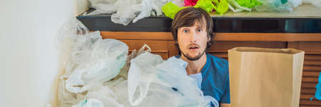 Man holding paper bag amid a pile of plastic bags. Zero waste concept. The concept of World...