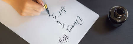 BANNER, LONG FORMAT dream big set goals take action. Calligrapher Young Woman writes phrase on white...