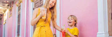 BANNER, LONG FORMAT Mom and son tourists on the Street in the Portugese style Romani in Phuket Town. Also called Chinatown or the old town. Traveling with kids conceptの写真素材