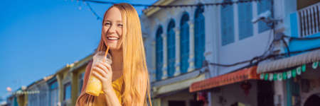 Woman tourist on the Street in the Portugese style Romani in Phuket Town. Also called Chinatown or the old town BANNER, LONG FORMATの写真素材