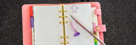 Notepad and stationery on a black background. Planner for business and study. Fans of stationery...