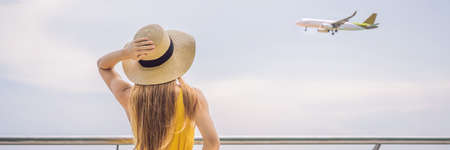 Start of her journey. Beautiful young woman ltraveler in a yellow dress and a yellow suitcase is...
