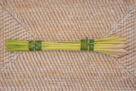 Eco-friendly product packaging concept. Lemongrass wrapped in a banana leaf, as an alternative to a plastic bag. Zero waste concept. Alternative packagingの写真素材