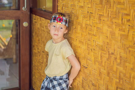 Boy tourist in sarong, national Balinese clothingの写真素材