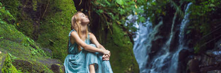 Woman traveler on a waterfall