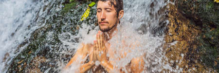 Young man tourist in Holy springs Sebatu in Baliの写真素材