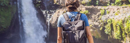 Man traveler on a waterfallの写真素材