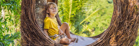 Boy tourist enjoying in straw nestの写真素材