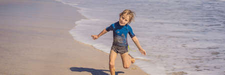 Cute little boy having fun on tropical beach during summer vacation