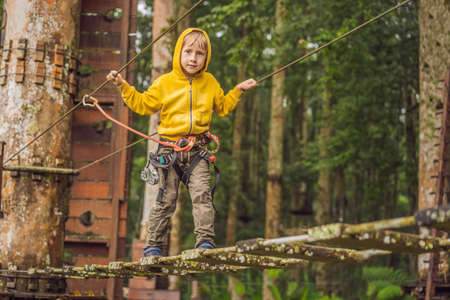Little boy in a rope park. Active physical recreation of the child in the fresh air in the park....