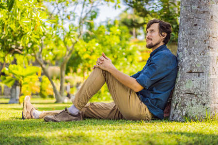 Young man in Water Palace Soekasada Taman Ujung Ruins on Bali Island in Indonesia. Amazing old architecture. Travel and holidays backgroundの写真素材
