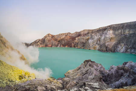 The Ijen volcano or Kawah Ijen on the Indonesian language. Famous volcano containing the biggest in the world acid lake and sulfur mining spot at the place where volcanic gasses come from the volcanoの写真素材