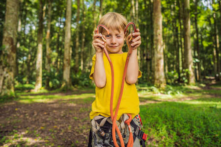 Little boy in a rope park. Active physical recreation of the child in the fresh air in the park....