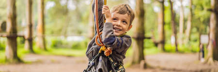 Little boy in a rope park. Active physical recreation of the child in the fresh air in the park....