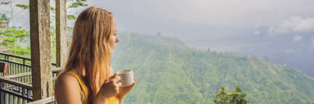 Young woman drinks coffee in a cafe in the mountains BANNER, LONG FORMAT