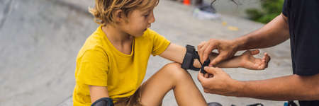 Trainer helps the boy to wear knee pads and armbands before training skate board BANNER, LONG FORMATの写真素材