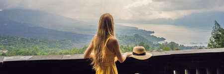 Woman traveler looking at Batur volcano. Indonesia BANNER, LONG FORMATの写真素材