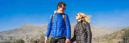 BANNER, LONG FORMAT Young couple man and woman visit the Bromo volcano at the Tengger Semeru...