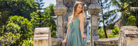Young woman in dress in Water Palace Soekasada Taman Ujung Ruins on Bali Island in Indonesia. Amazing old architecture. Travel and holidays background BANNER, LONG FORMATの写真素材