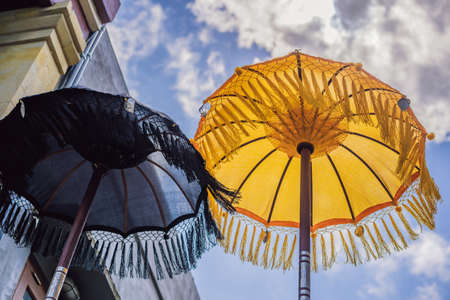 Typical Balinese umbrellas placed in the home temple Ubud, Bali - Indonesiaの写真素材