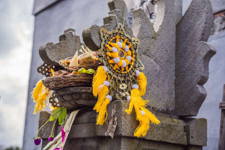 Traditional balinese offerings to gods in Bali with flowers and aromatic sticksの写真素材