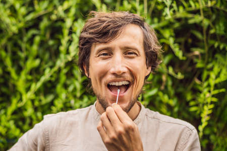 Man doing DNA test with cotton swab. Test for home useの写真素材