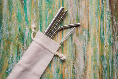 Steel drinking straws on painted wooden background. Zero waste conceptの写真素材