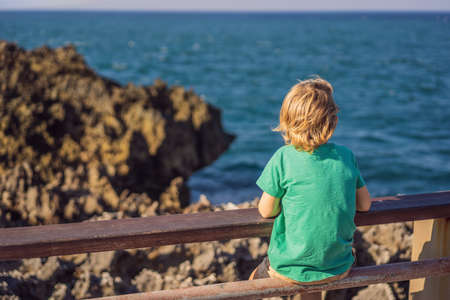 Boy traveler on amazing Nusadua, Waterbloom Fountain, Bali Island Indonesia. Traveling with kids conceptの写真素材