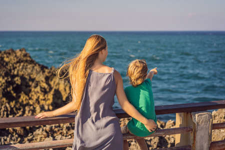 Mom and son travelers on amazing Nusadua, Waterbloom Fountain, Bali Island Indonesia. Traveling with kids conceptの写真素材