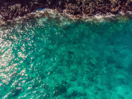 Couple snorkeling in the blue sea ocean and coral background aerial top view