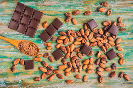 Chocolate and cocoa beans on color wooden backgroundの写真素材