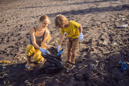 Mother and son are cleaning up the beach. Natural education of childrenの写真素材