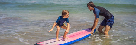 Father or instructor teaching his 5 year old son how to surf in the sea on vacation or holiday. Travel and sports with children concept. Surfing lesson for kids BANNER, LONG FORMATの写真素材
