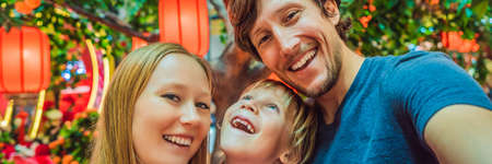 Happy family celebrate Chinese New Year look at Chinese red lanterns BANNER, LONG FORMAT