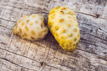 Fresh noni fruit and noni slice on wooden  and space.の写真素材