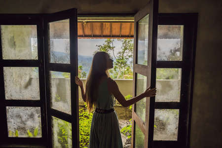 Woman tourist in abandoned and mysterious hotel in Bedugul. Indonesia, Bali Island. Bali Travel Conceptの写真素材