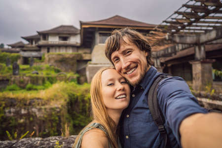 Happy couple in love in abandoned and mysterious hotel in Bedugul. Indonesia, Bali Island. Honeymoon in Baliの写真素材