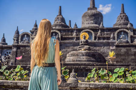 Young woman tourist in budhist temple Brahma Vihara Arama Banjar Bali, Indonesia