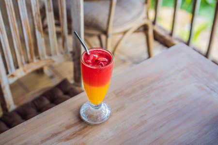 Two tone cocktail in a glass in the cafeの写真素材