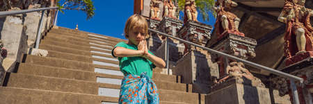 Young boy tourist in Buddhist temple Brahma Vihara Arama Bali