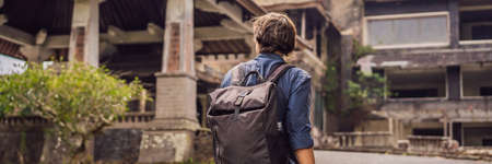 Man tourist in abandoned and mysterious hotel in Bedugul.の写真素材