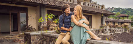 Happy couple in love in abandoned and mysterious hotel in Bedugul.