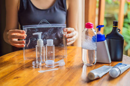 Travel kit for transporting cosmetics on an airplane. Cosmetics are ready to be poured into small...