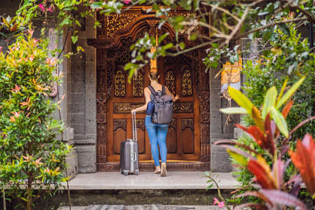 Young beautiful woman check in authentic hotel in Bali. Tourism Bali Conceptの写真素材
