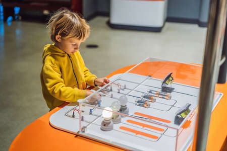 Boy in science class. The child is engaged in science