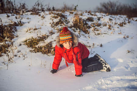 Boy in red fashion clothes playing outdoors.の写真素材