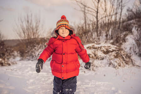 Boy in red fashion clothes playing outdoors.の写真素材